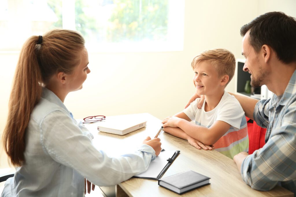 Teacher meeting with student and his mother