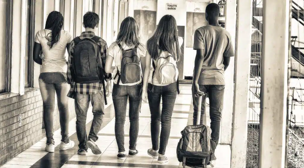 Black and white photo of students walking away