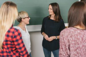 Four women talking in classroom