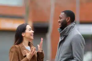 Man and woman talking outside a school