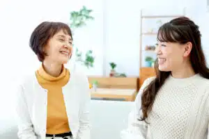 Two women smiling and talking to each other