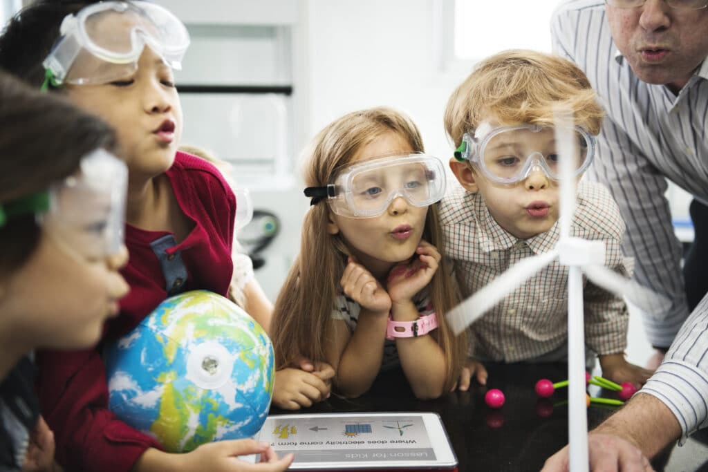 Elementary students wearing goggles during a science experiment