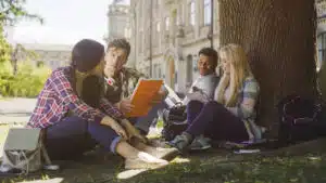 College students studying together in front of a college building