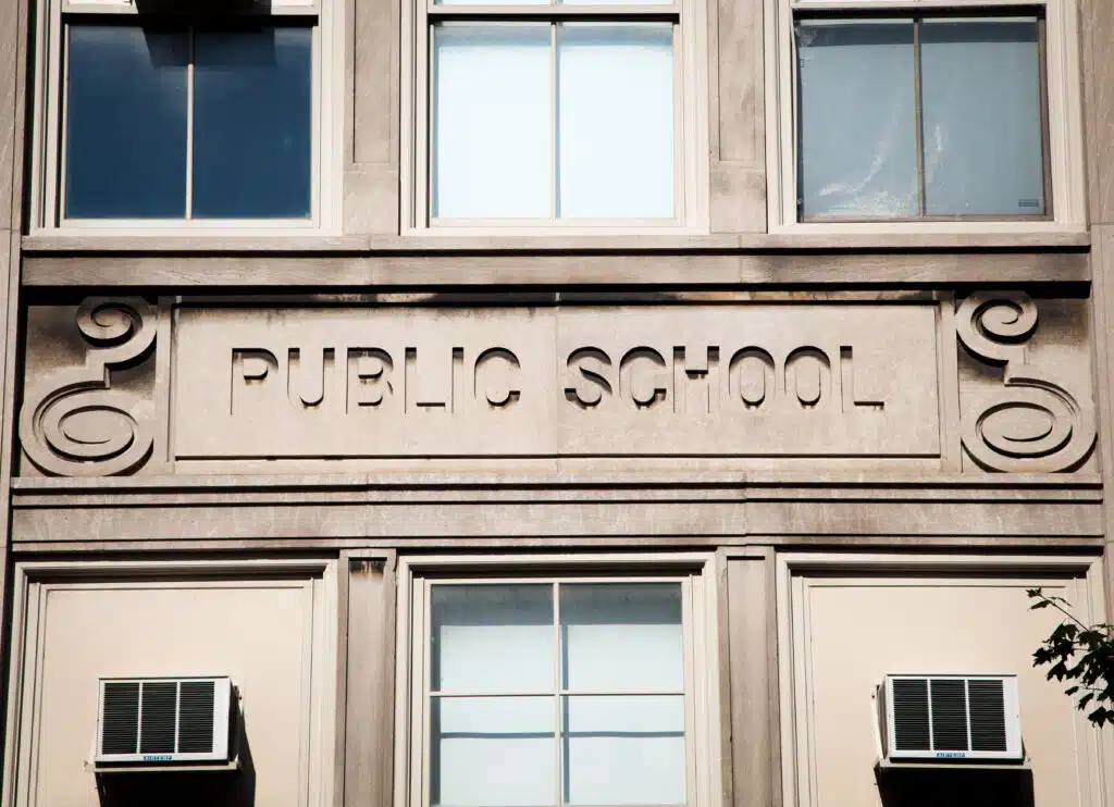 School building with "Public School" carved above the door