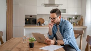 Father looking at a computer at home